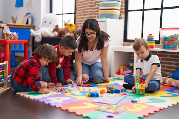 imgi 130 maestra grupo ninos jugando juego rompecabezas matematicas sentada suelo jardin infantes 839833 26743